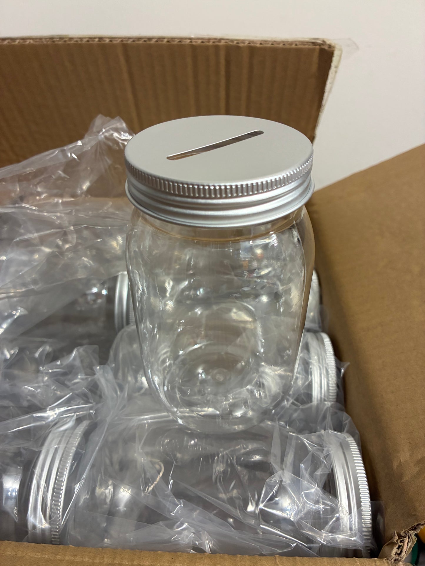 CLEAR PLASTIC JAR WITH SLOTTED LID